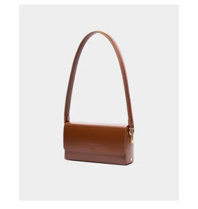 Minimalist brown leather shoulder bag for women, elegant baguette handbag for daily commute.