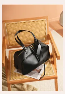Elegant black leather Boston handbag for women, spacious shoulder bag for daily commute.