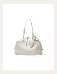 Detail view of minimalist leather Boston shoulder bag in off-white, elegant everyday commuting style.