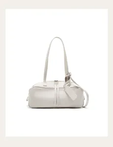 Close-up detail of the off-white leather shoulder bag showing delicate texture and sleek zipper.