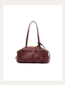 Burgundy leather shoulder bag detail, premium bowling bag design with fine metal zipper.