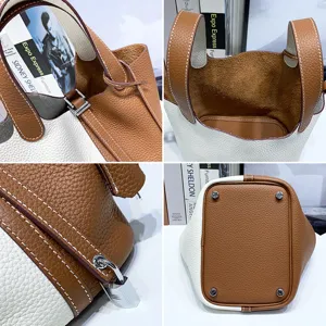 Top-layer cowhide leather bucket bag, bicolor handbag with metal lock, stylish daily tote for women.