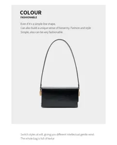 Minimalist black underarm shoulder bag with chic thin strap and gold hardware details.