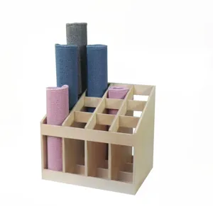 Wooden Montessori rug storage rack detail showing multi-colored working mats in slots.