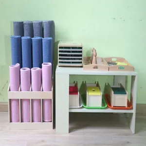 Montessori carpet rack and wooden cabinet set with colorful work rugs for early education.