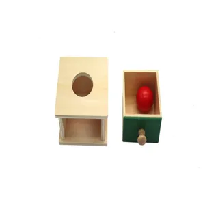 Montessori wooden ball drop box detail view with red ball and drawer for kids early learning.