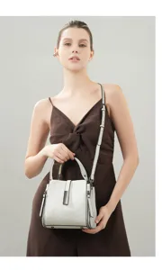 Close-up view of elegant leather handbag showing refined metal hardware and stitching.