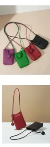 Leather phone bag detail showing exquisite knot design and versatile crossbody strap.