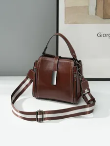 Stylish women's retro brown leather shoulder crossbody bag with striped strap and chic clasp.