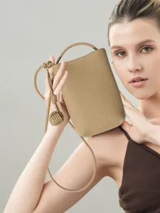 Genuine leather vertical phone bag with stylish knotted strap design for women crossbody