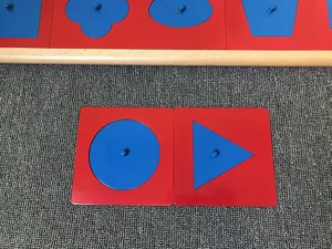 Montessori metal geometric inset board detail view showing colorful shape sorting educational toy parts