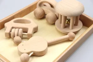 Wooden baby rattle set and push car detail showing smooth natural wood texture and safe design for infants.