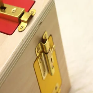 Wooden educational lock box detail showing metal latches and hardware for children learning skills.