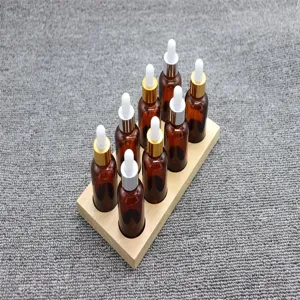 Amber glass dropper bottles set with wooden stand, ideal detail view for science tools.