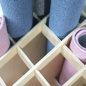 Montessori wooden carpet storage rack and organizer cabinet with rolled colorful work rugs
