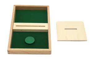 Montessori wooden educational toy detail, wooden tray with green felt lining and disc drop slot.