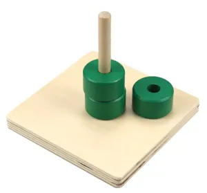 Close-up detail of Montessori wooden educational stacking toy with green rings and wooden peg.
