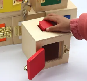 Wooden educational shape matching lock box toy detail showing child interacting with blocks and locks.