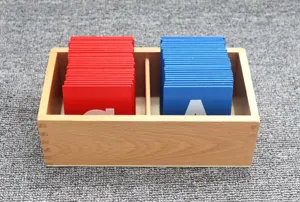 Closeup of Montessori wooden box with red and blue sandpaper letters for early education.