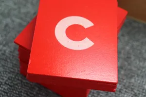 Detail shot of red Montessori sandpaper letter C card, wooden early education toy.