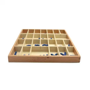 Wooden alphabet sorting box detail showing neatly arranged blue Montessori letters inside compartments.