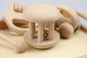 Wooden baby rattle and toy set detail, natural wood, safe infant early education aids.
