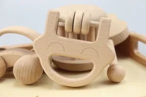 Natural solid wood baby toys set including hand rattle and wooden toy car for infant early learning.