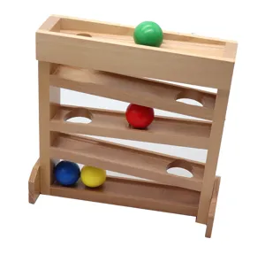 Detail view of the wooden ball tracker toy showing colorful balls on smooth slide ramp.