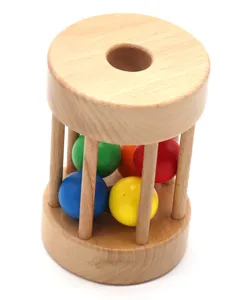 Wooden Montessori rolling drum toy with colorful balls for infant early education.