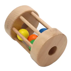 Montessori wooden rolling drum baby toy with colorful balls for sensory and motor skills development.