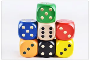 Close up detail view of colorful wooden dice stack showing fine texture and smooth finish.