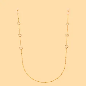 Nahaufnahme Detail der goldenen Strass Herz Brillenkette mit funkelnden Perlen Anhänger.