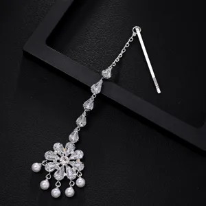 Crystal flower hair chain detail, sparkling forehead ornament and bridal jewelry accessory.