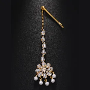 Detailed closeup of Indian bridal forehead hair chain with sparkling zircon crystals and pearls.