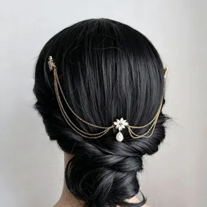 Detail shot of exquisite multi-layer gold hair chain with rhinestone teardrop updo accessory.
