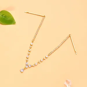Exquisite bridal rhinestone hair chain detail, featuring teardrop crystals and gold pins.