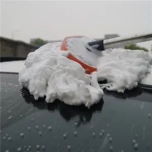 Car wash mop detail view showing soft white bristle brush head and telescopic handle cleaning vehicle roof.