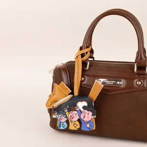 Brown PU leather handbag detail featuring a cute cartoon horse charm, stylish and trendy accessory.