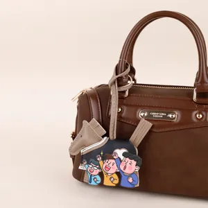 Brown PU leather handbag with top handles, metal logo plate and unique cartoon horse charm.
