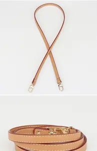 Vue détaillée de la fine lanière de sac en cuir avec du cuir de vachette et du métal.