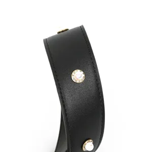 Black leather bag strap accessory with sparkling rhinestone and pearl decor, stylish.