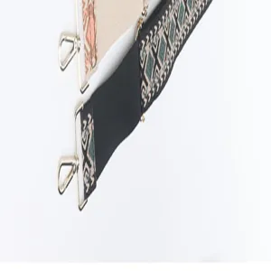 Close up view of wide replacement bag strap with geometric pattern and metal hardware hooks.