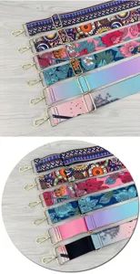 Adjustable bag strap detail, vibrant floral and geometric print, durable metal hardware.