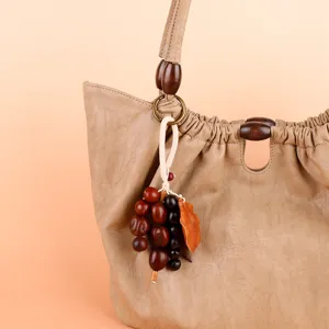 Detail view of natural plant seed pod wind chime bag pendant, handmade healing bell hanging decor.