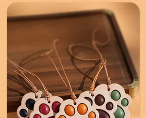 Leather cat paw keychain and car mirror pendant, cute handmade leather bag charm accessory.