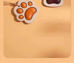 Detailed shot of cute leather cat paw keychain charm, premium vegetable-tanned cowhide material.