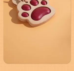 Vegetable tanned leather cat paw car hanging ornament and cute bag charm keychain detail.