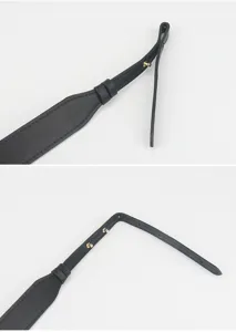 Detail view of black genuine leather replacement shoulder strap with adjustable metal rivet studs.
