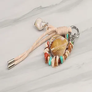 Colorful braided keychain lanyard with natural shell and stone charms for daily use.