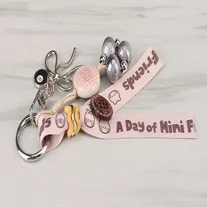 Cute pink ribbon keychain with bow and beads charm, stylish DIY bag pendant accessory.